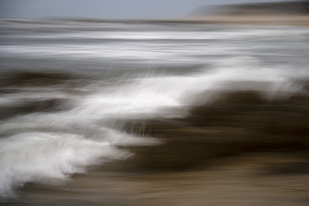 The motion of the waves as they recede from the beach