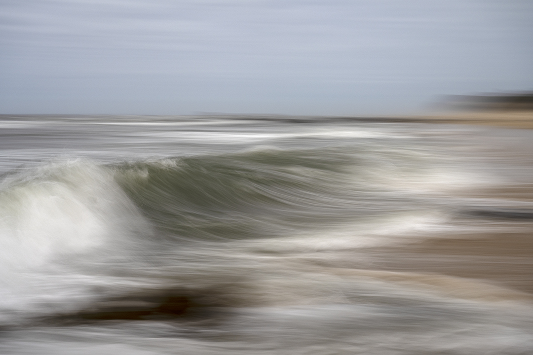 The motion of the waves as they recede from the beach